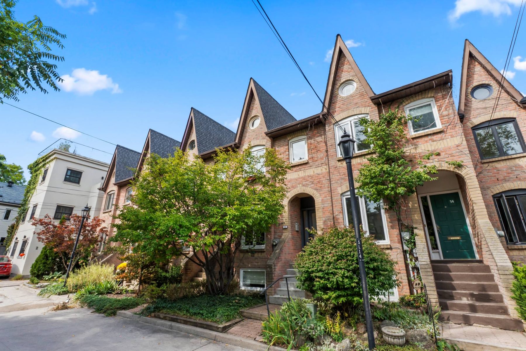 St James Court streetscape with the row of pointed-gable brick townhouses